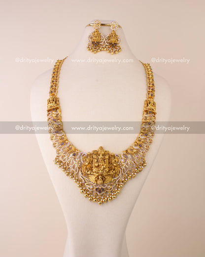 Nakshi long necklace featuring Goddess Lakshmi pendant, CZ stones, and golden bead hangings.