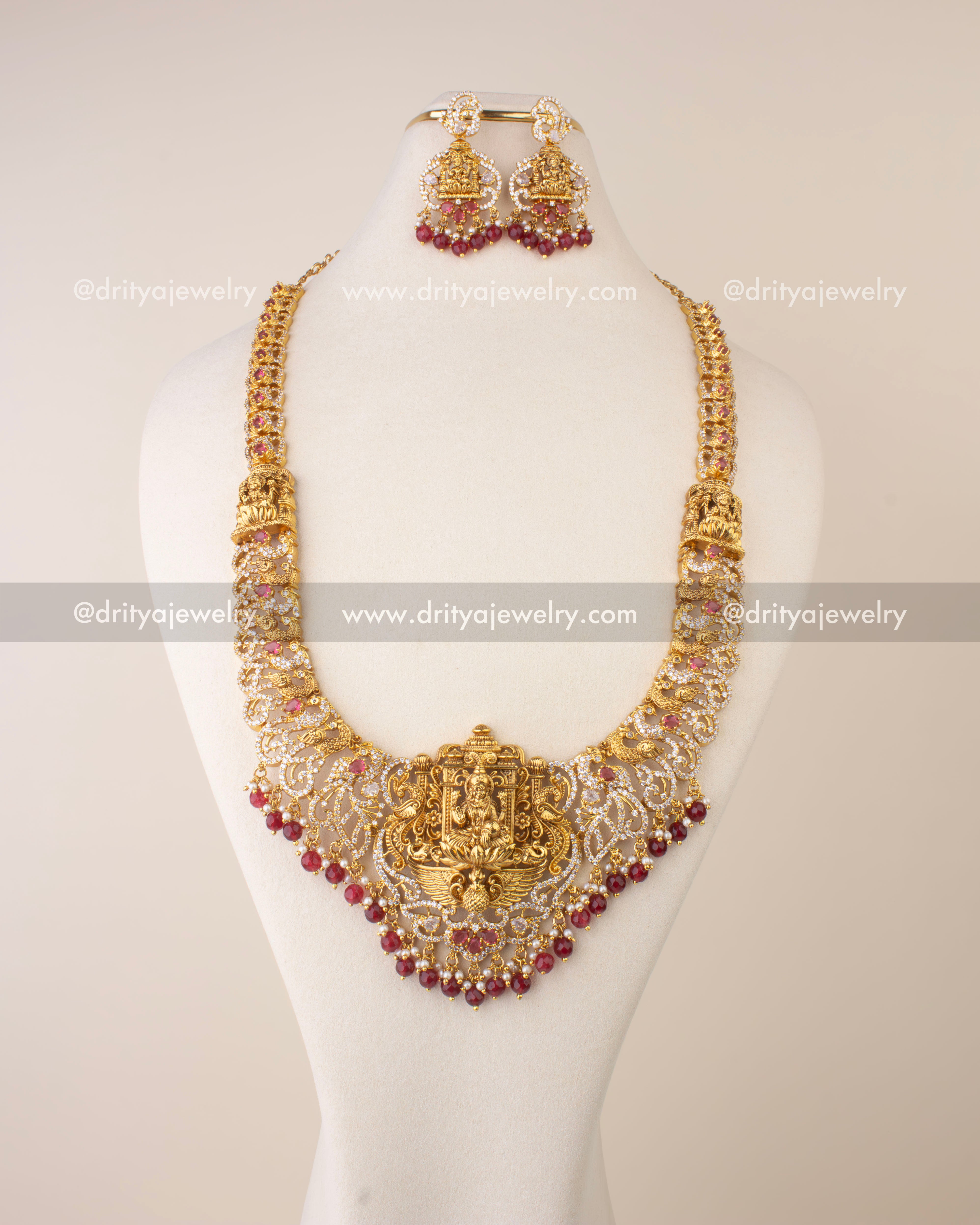 Traditional Nakshi long necklace featuring Goddess Lakshmi motif with CZ stones and ruby red bead hangings.