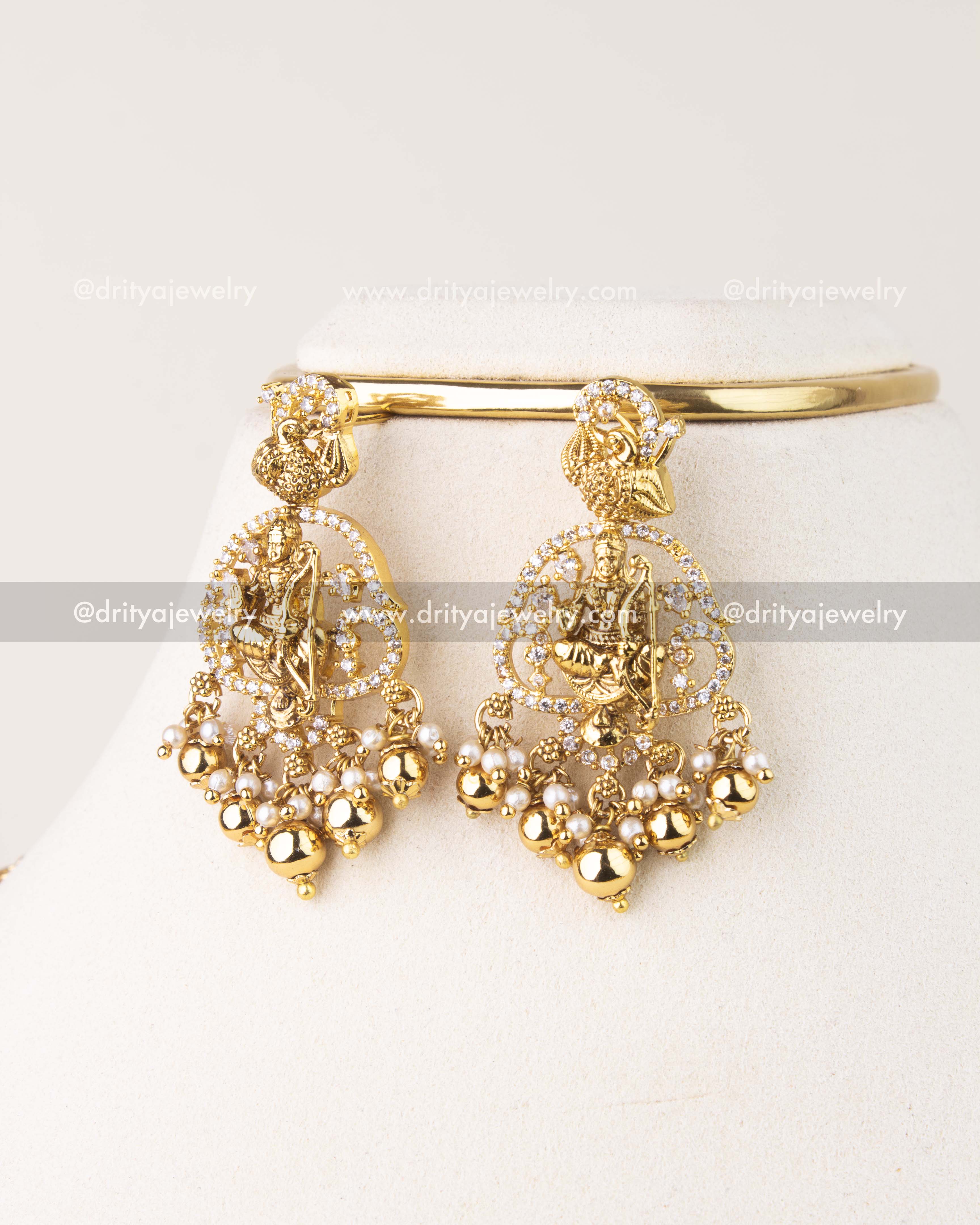 Traditional long haram set featuring Nakshi Ram Parivar motif, AD stones, and pearl drops in antique gold finish.