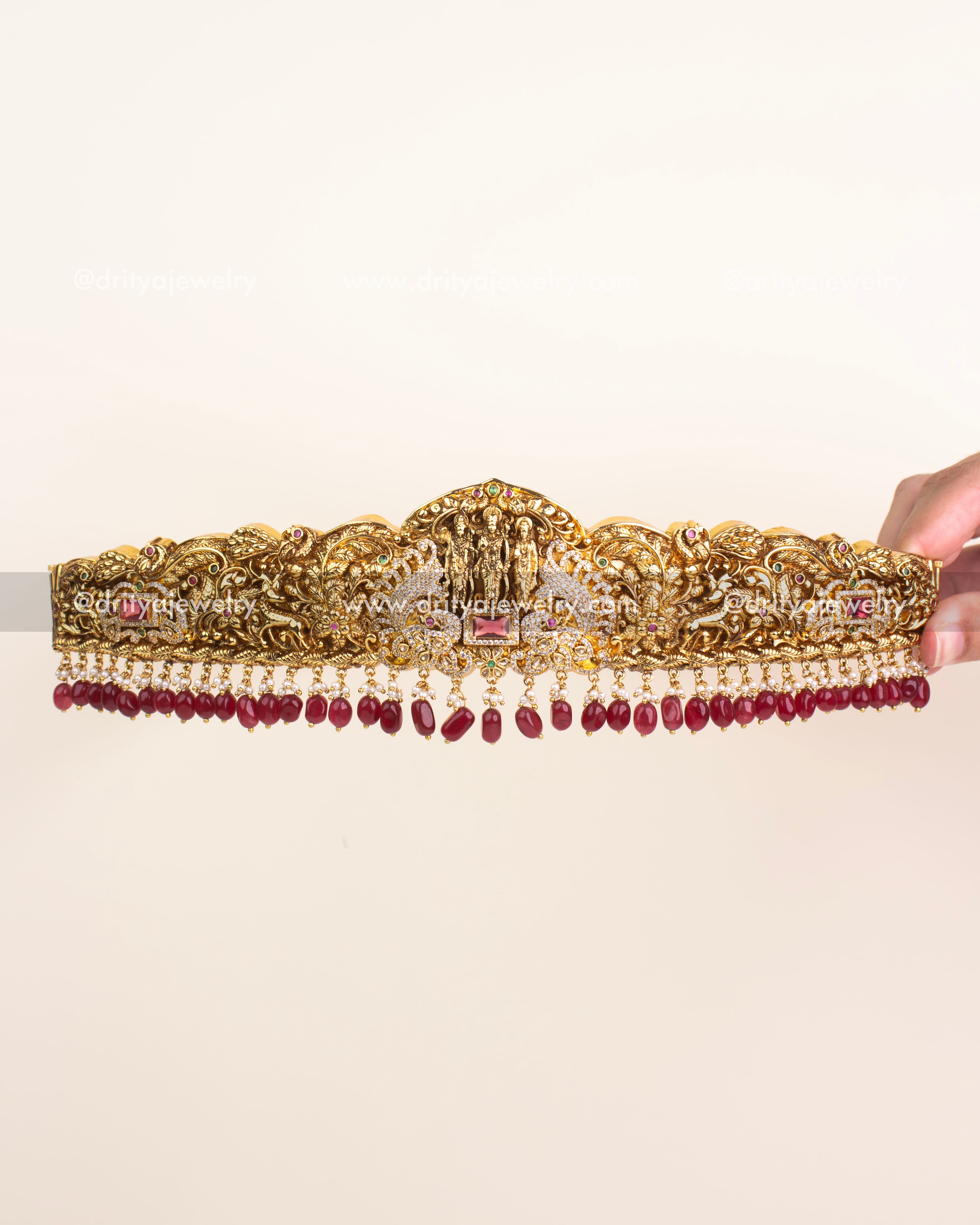 Antique gold Nakshi vadanam featuring Ram Parivar motif with ruby bead drops.
