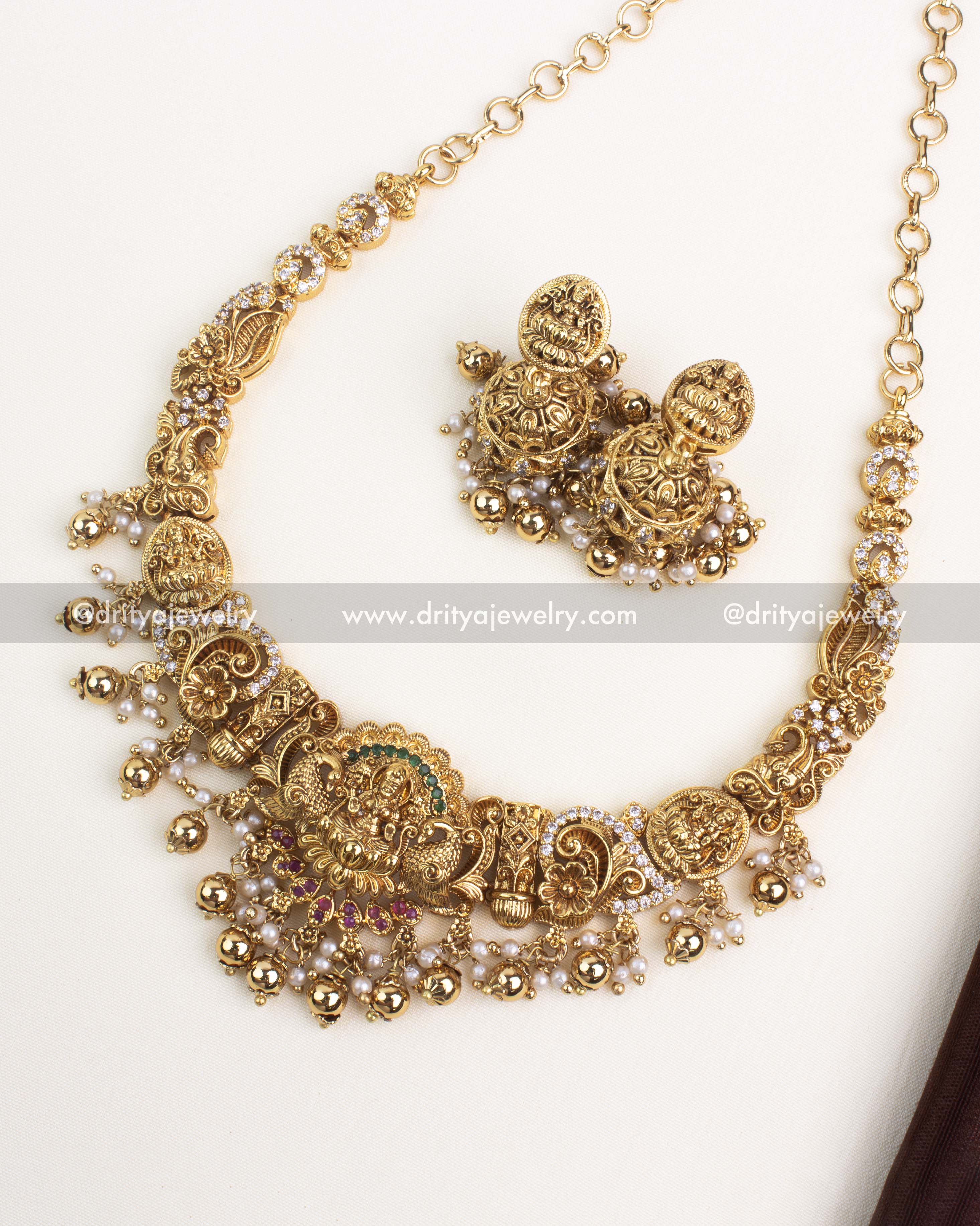 Antique gold Nakshi short necklace with temple-inspired design and gold ball danglings.