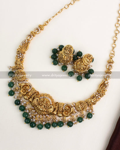 Antique gold Nakshi short necklace with white stones, green beads, and traditional goddess pendant.