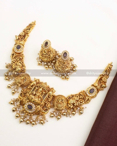 Antique gold nakshi short necklace set featuring goddess motif, peacock carvings, CZ stone accents, pearl drops, and matching jhumkas.