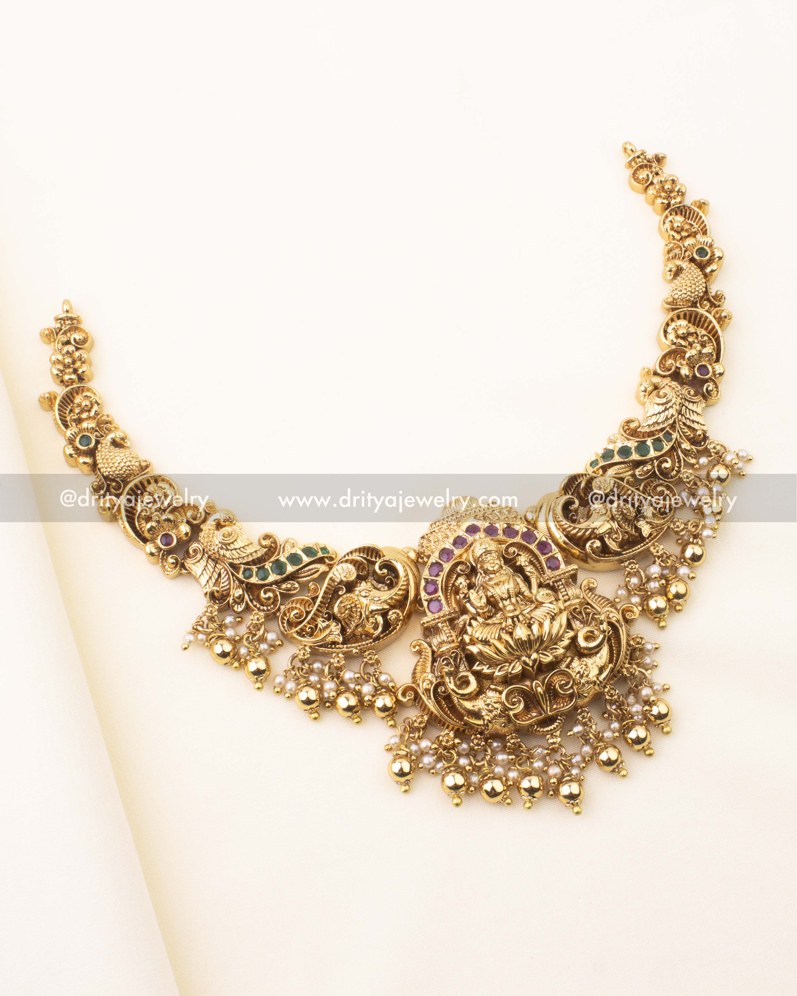 Temple-style short necklace featuring Goddess Lakshmi, Kemp stones, and pearl clusters.