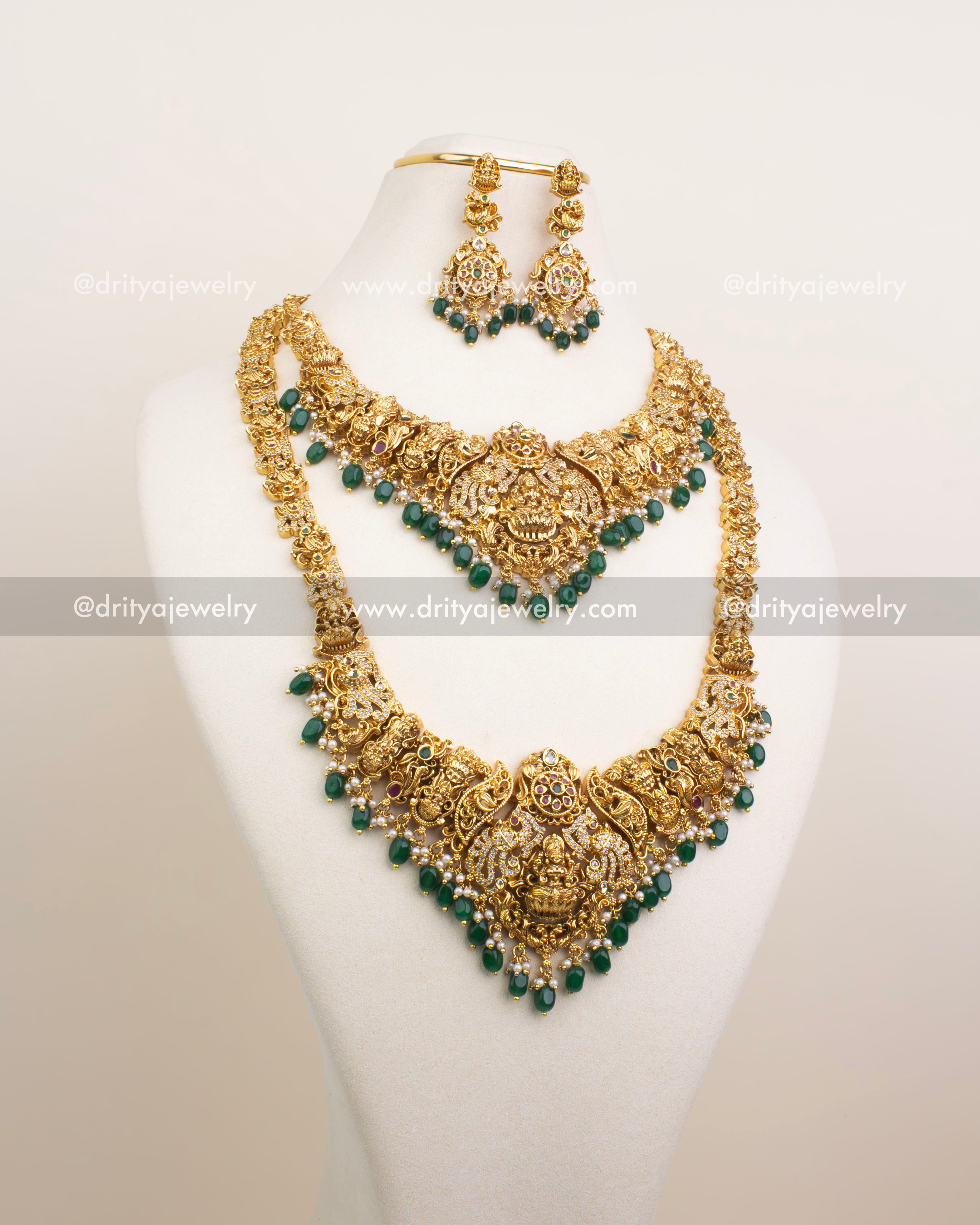 Gold-plated temple jewelry set with emerald green beads, including long necklace, short necklace, earrings, and maang tikka.