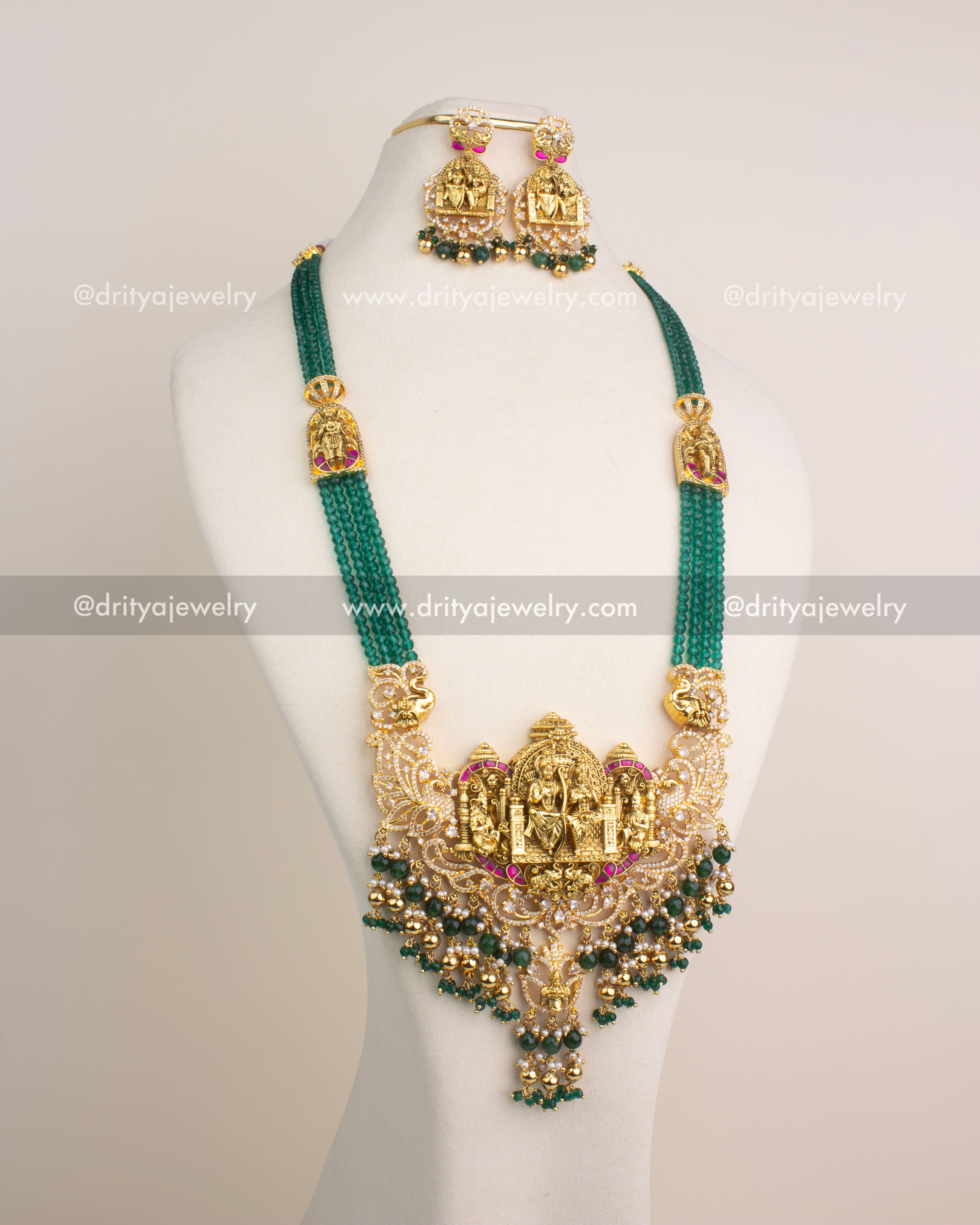 Antique gold Nakshi long necklace with Ram Parivar motif, green beads, and Kemp stones.