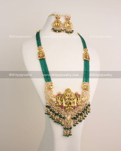 Antique gold Nakshi long necklace with Ram Parivar motif, green beads, and Kemp stones.