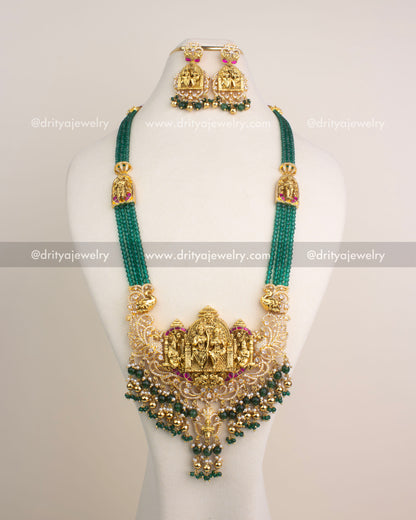 Antique gold Nakshi long necklace with Ram Parivar motif, green beads, and Kemp stones.