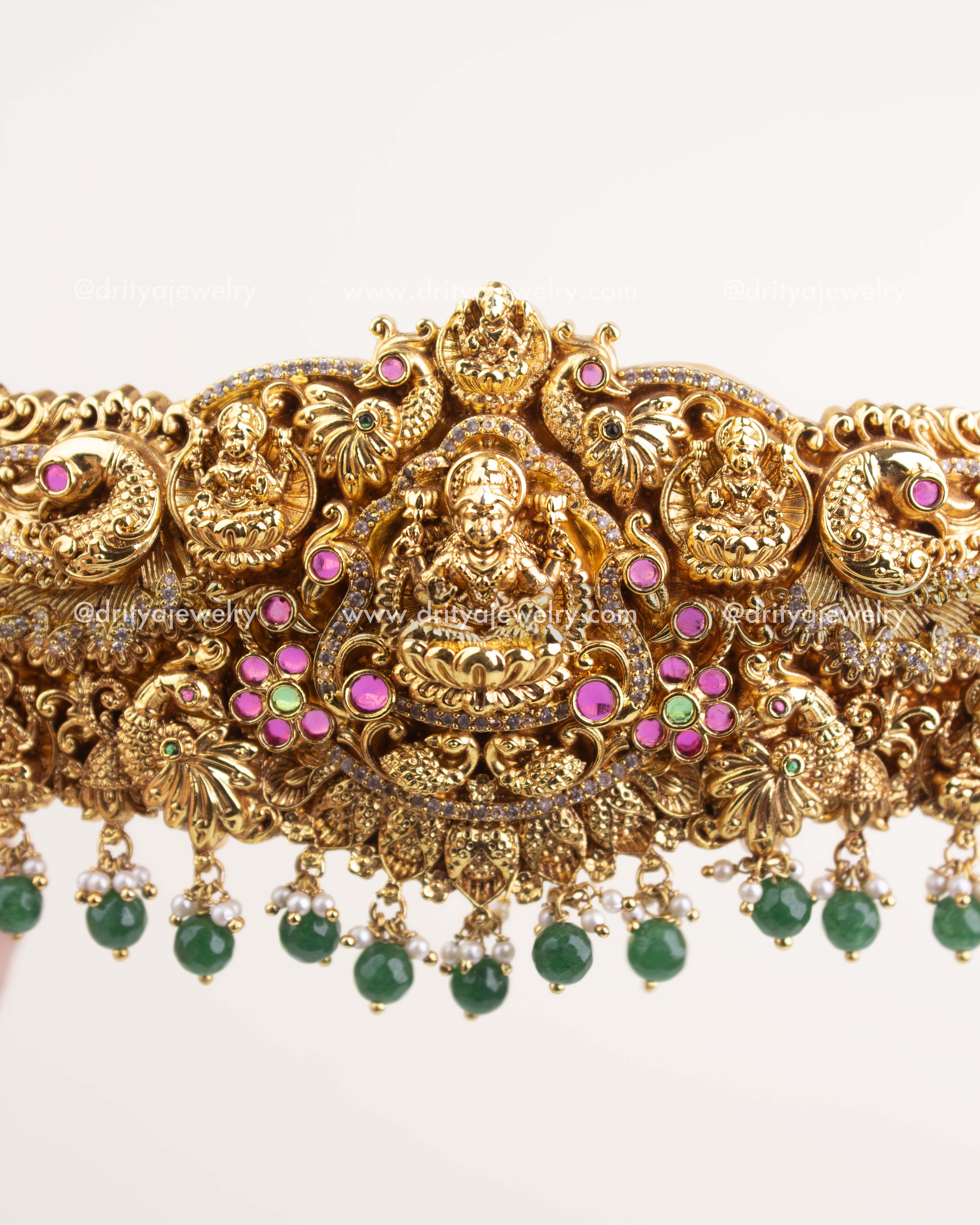 Detailed Goddess Lakshmi carving with Nakshi peacock motifs and intricate stone embellishments.
