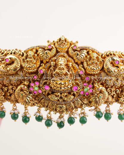 Detailed Goddess Lakshmi carving with Nakshi peacock motifs and intricate stone embellishments.