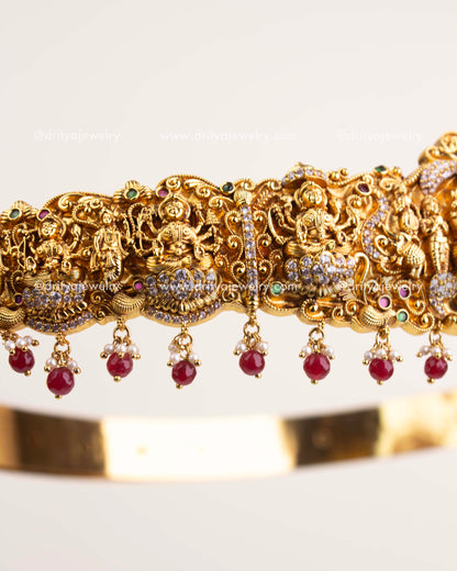 Side view showing intricate Nakshi craftsmanship and ruby bead embellishments.