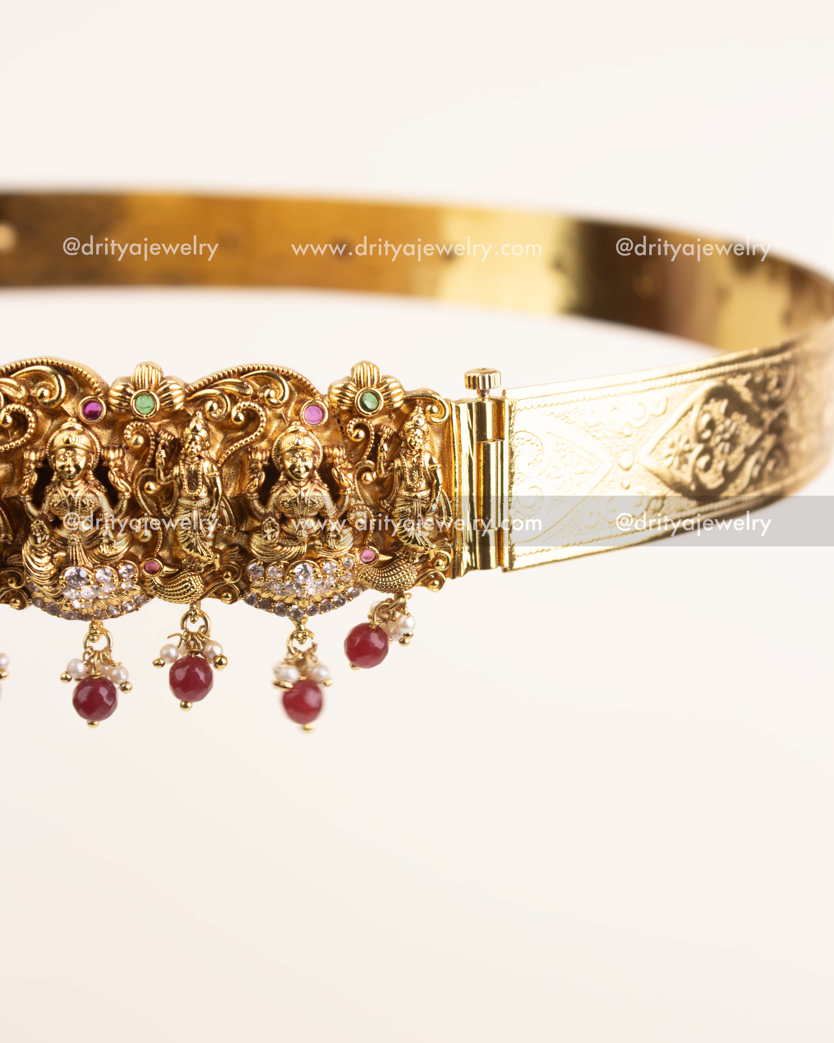 Side view showing intricate Nakshi craftsmanship and ruby bead embellishments.