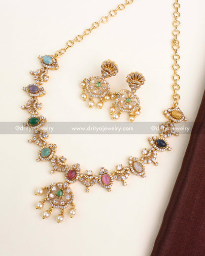 Gold-plated navaratna short necklace with multicolor oval stones, CZ halo detailing, and matching pearl dangler earrings by Dritya Jewelry.