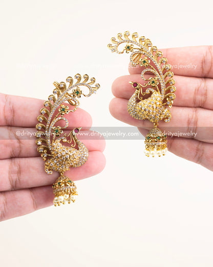 Gold-plated peacock design ear cuffs studded with CZ stones and finished with pearl danglers.