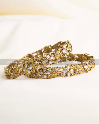 Victorian-polished bangle set with floral Polki motifs and antique gold detailing.
