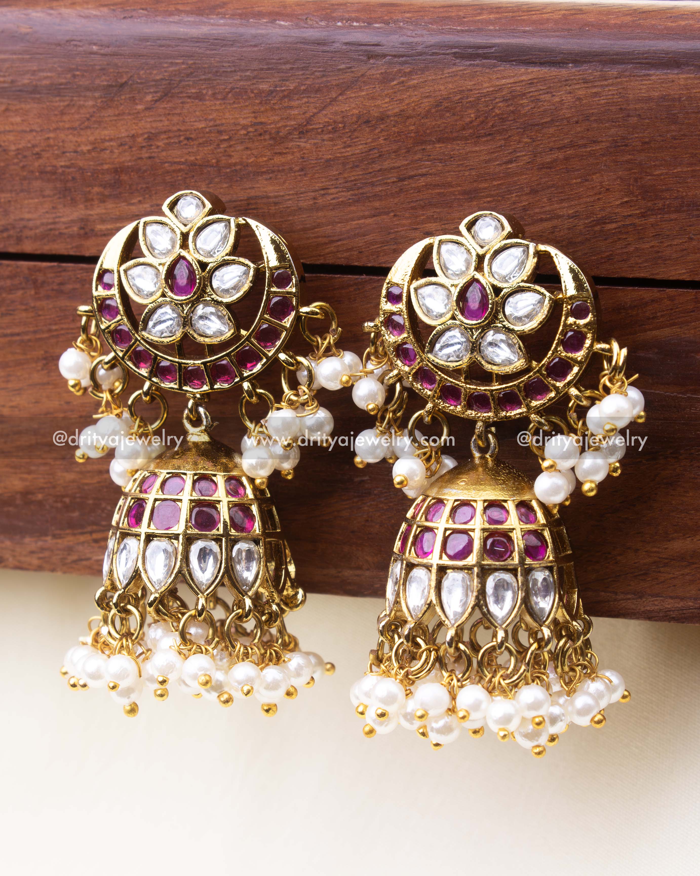 Premium polki kundan jhumkas with floral design, ruby accents, and pearl drops
