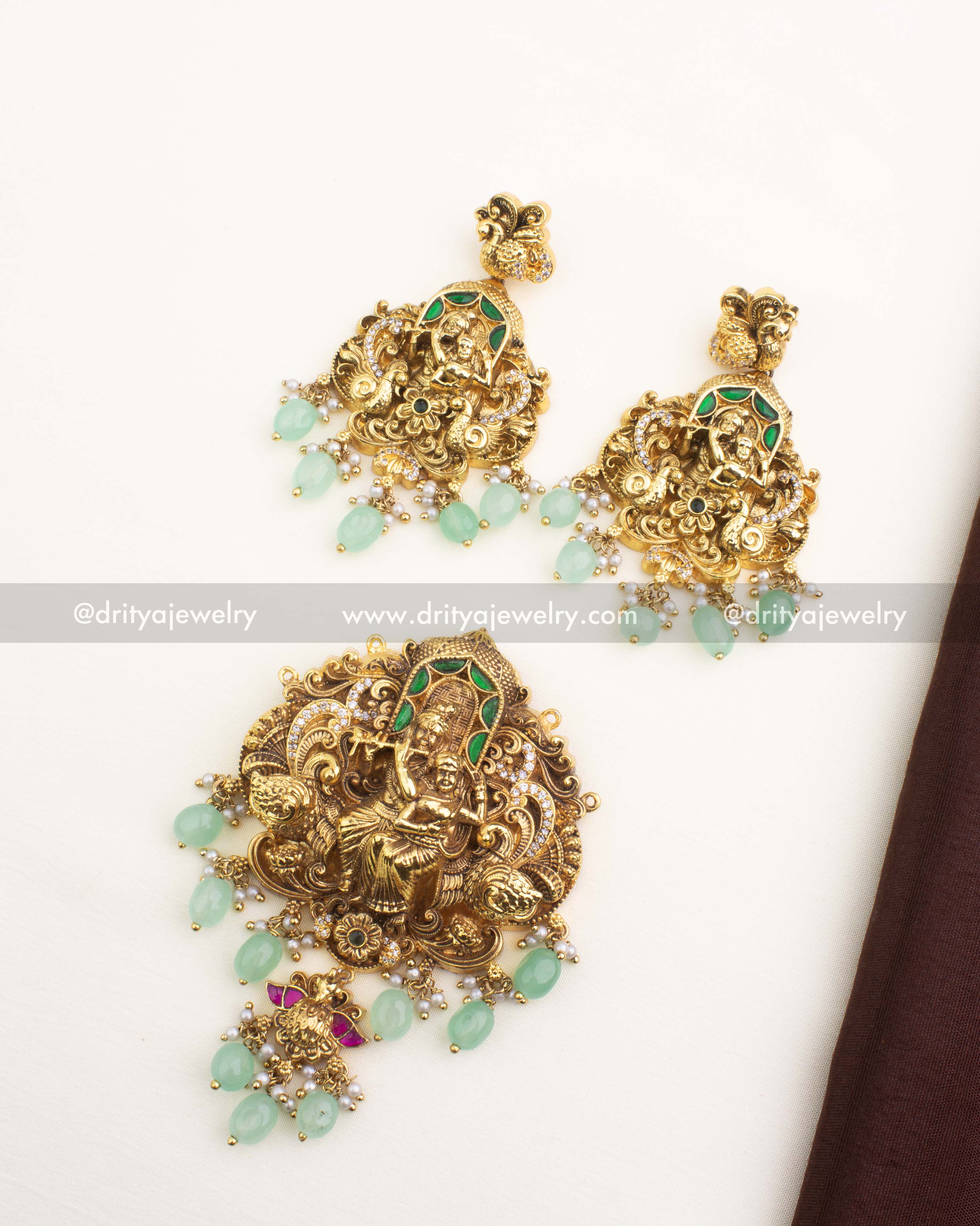 Antique gold Radha Krishna temple pendant set with mint-green beads, pearl hangings, and matching earrings.