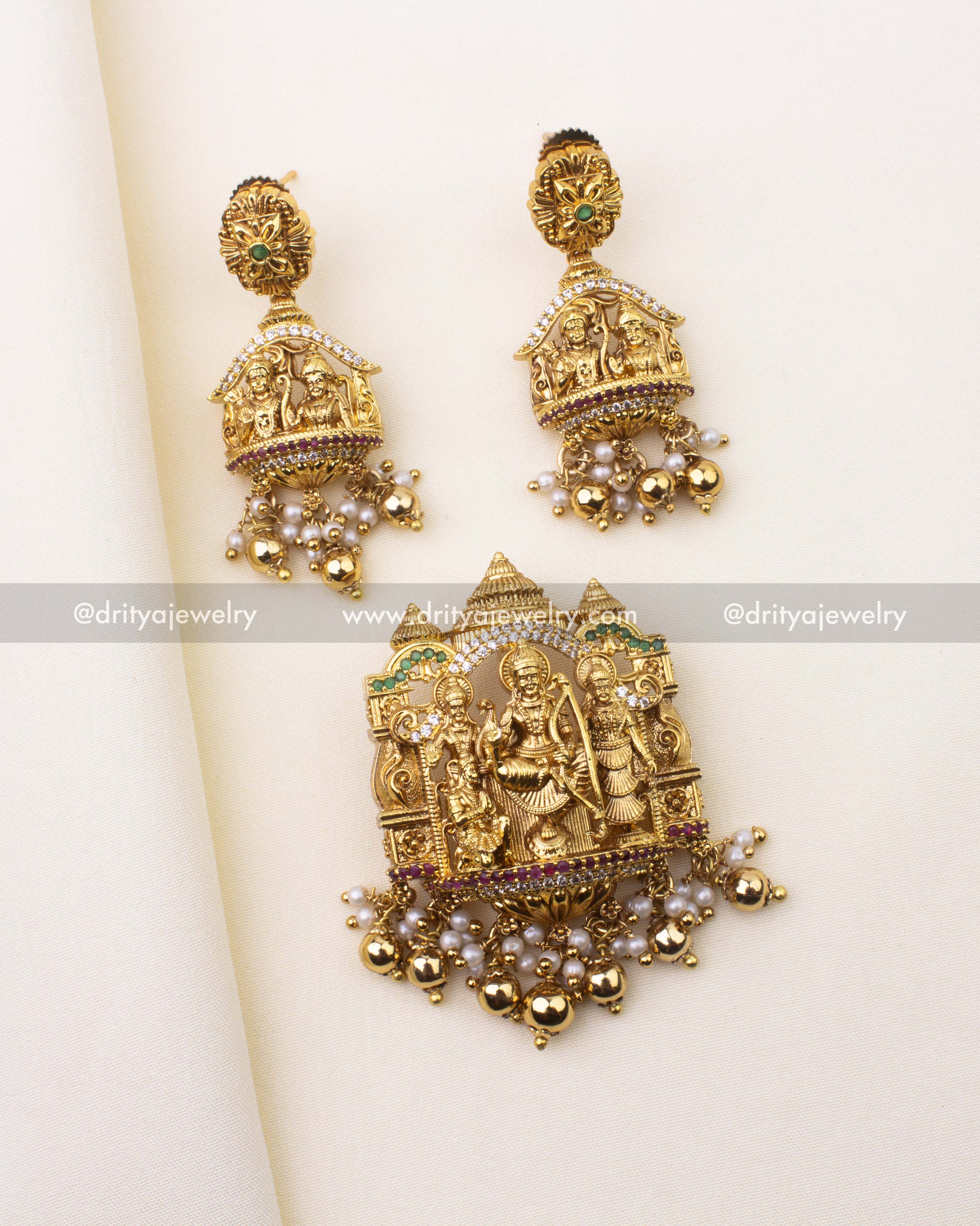 Antique gold Ram Parivar pendant set with matching earrings, ruby-green accents, and pearl drops.