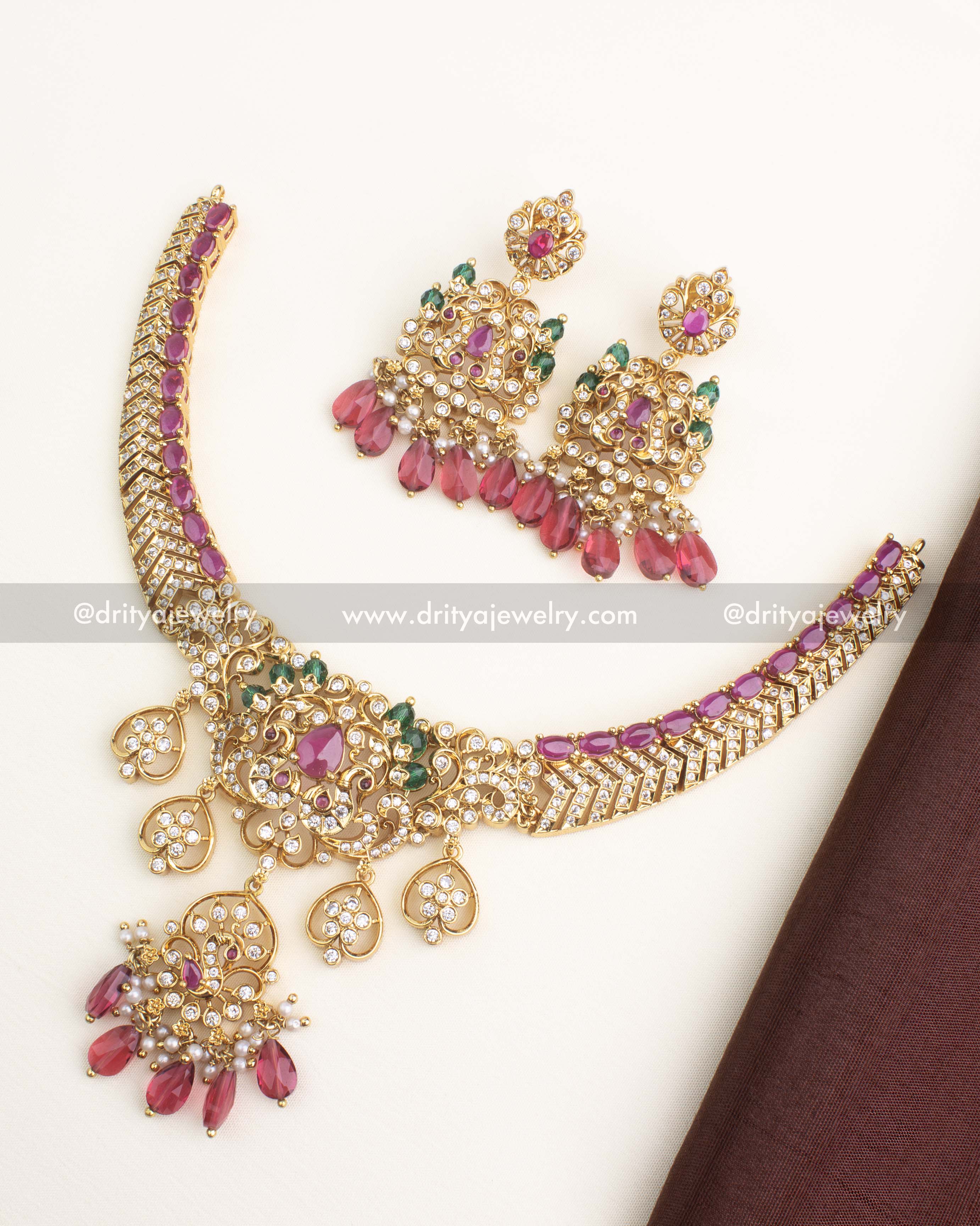 Gold-plated short necklace set with ruby pink stones, AD work, and matching chandbali earrings from Dritya Jewelry.