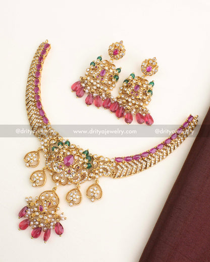 Gold-plated short necklace set with ruby pink stones, AD work, and matching chandbali earrings from Dritya Jewelry.