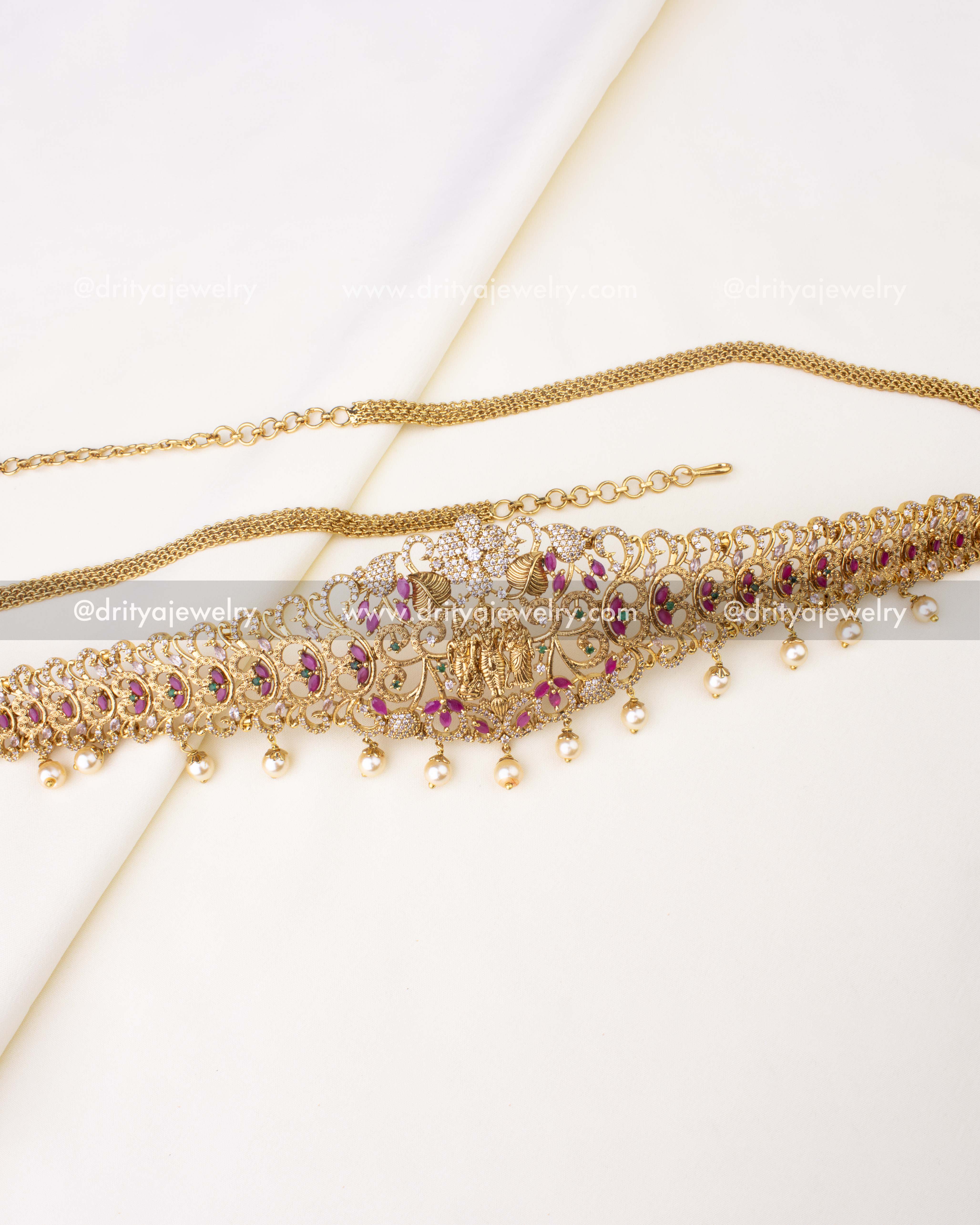 Gold-plated temple-style hip chain featuring Lakshmi motif, ruby accents, and pearl drops.
