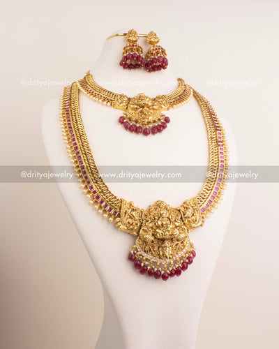 Dual-layered temple jewelry set with Lakshmi Devi motif and ruby red stone detailing.