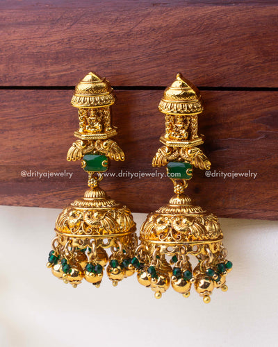 Ornate dome-shaped temple jhumkas with nakshi detailing and green bead hangings.