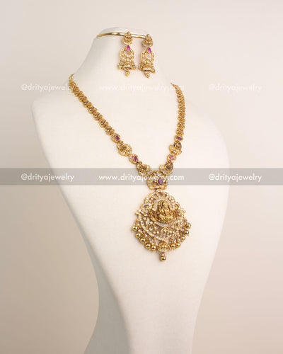 Antique gold temple long necklace with Lakshmi Devi pendant and ruby stones.