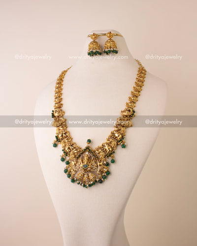 Temple long necklace featuring Lord Ganesha pendant with green beads and antique gold polish.