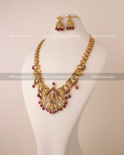 Temple-style long necklace with Lord Ganesha pendant and ruby bead drops.
