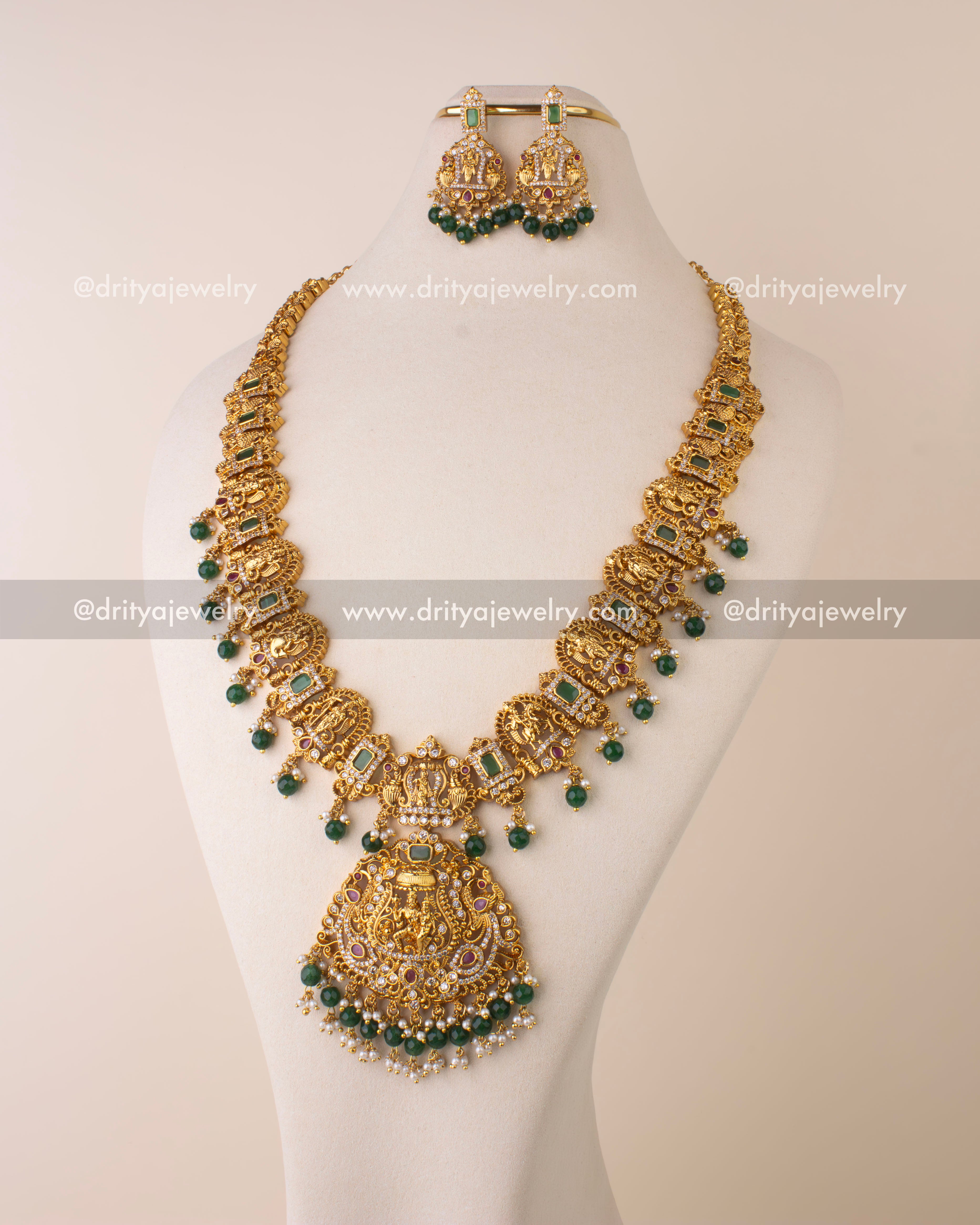 Temple-style long necklace with intricate Lord Narasimha pendant, CZ stones, ruby accents, and green bead danglers.
