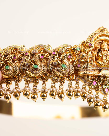 Side view showing ornate Nakshi craftsmanship, floral detailing, and hanging pearl beads.