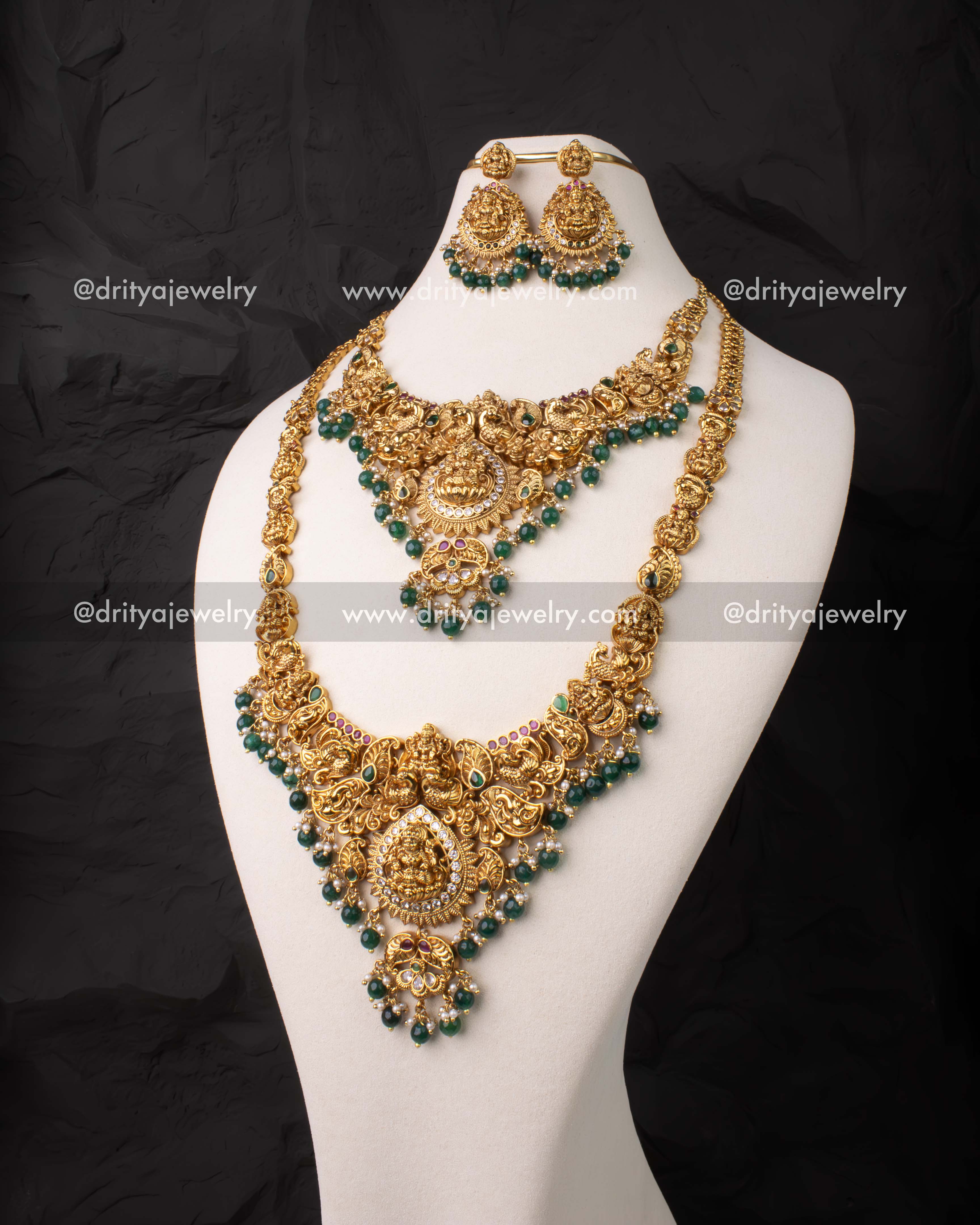 Full bridal temple jewelry set with short and long necklaces featuring Lakshmi motifs and green beads.