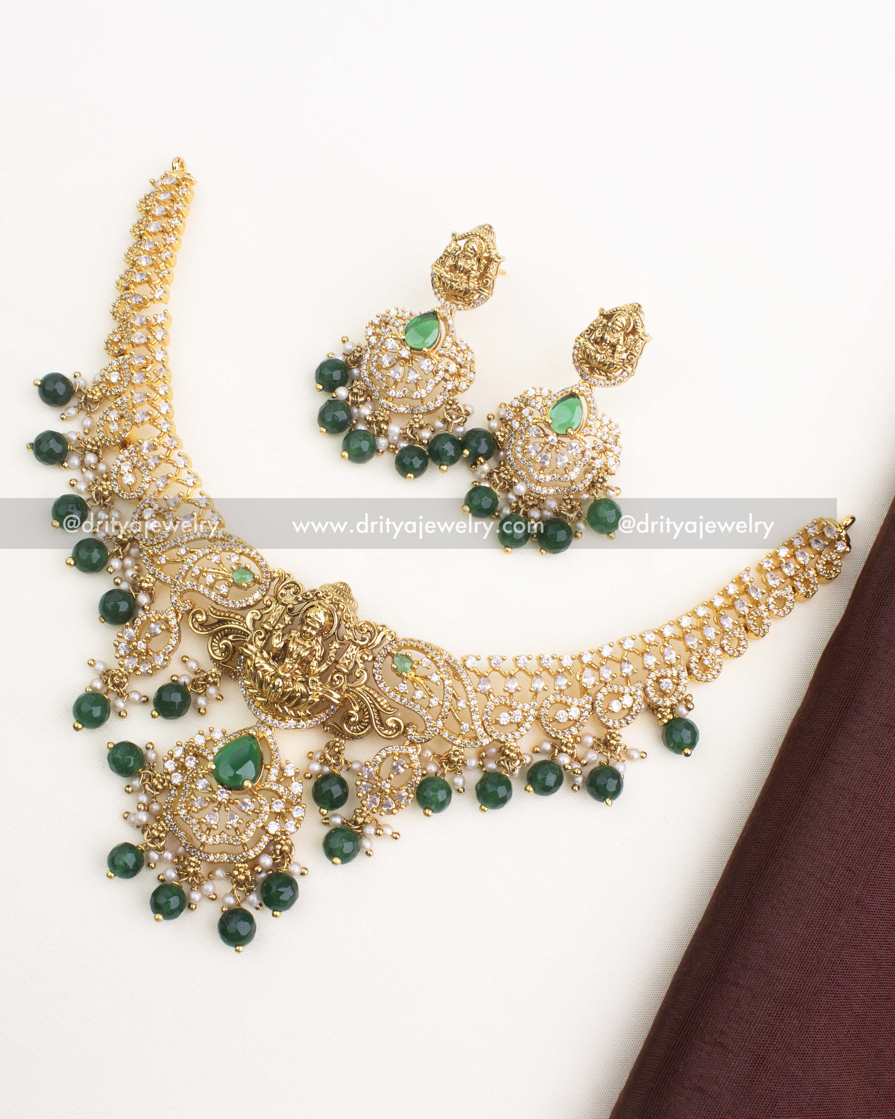 Gold-plated temple short necklace set with nakshi Lakshmi pendant, CZ stones, and emerald green bead drops from Dritya Jewelry.