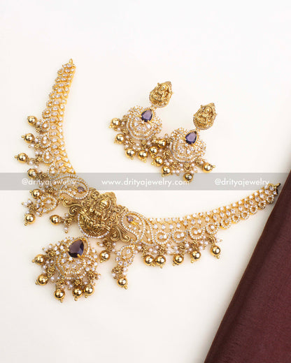 Antique gold temple short necklace with CZ stones, Lakshmi pendant, and purple stone drops.