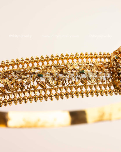 Side view showcasing intricate filigree foliage and bead edge design in antique gold polish.
