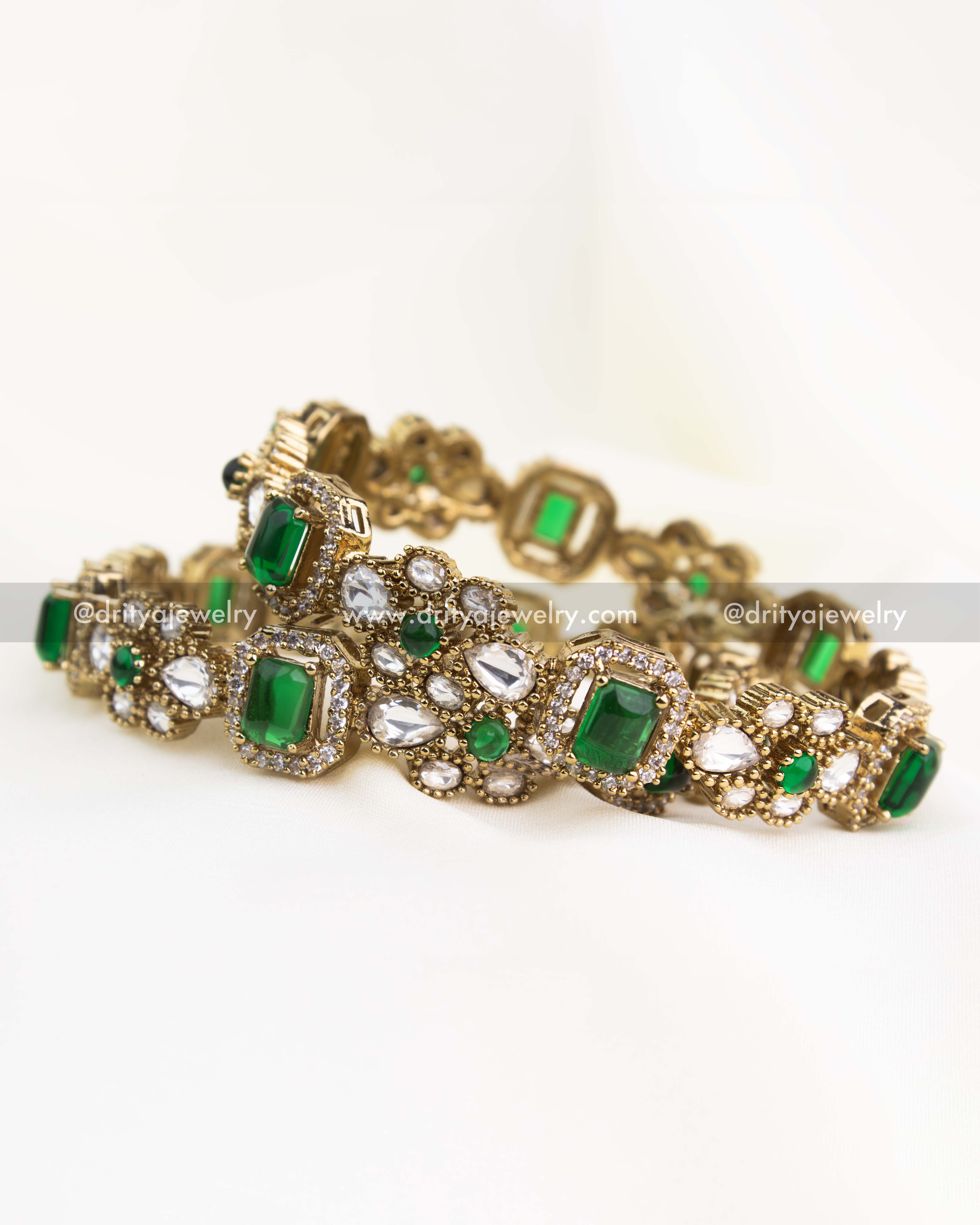 Elegant Victorian-style bangle set with green gemstones and kundan embellishments in a gold-plated frame.