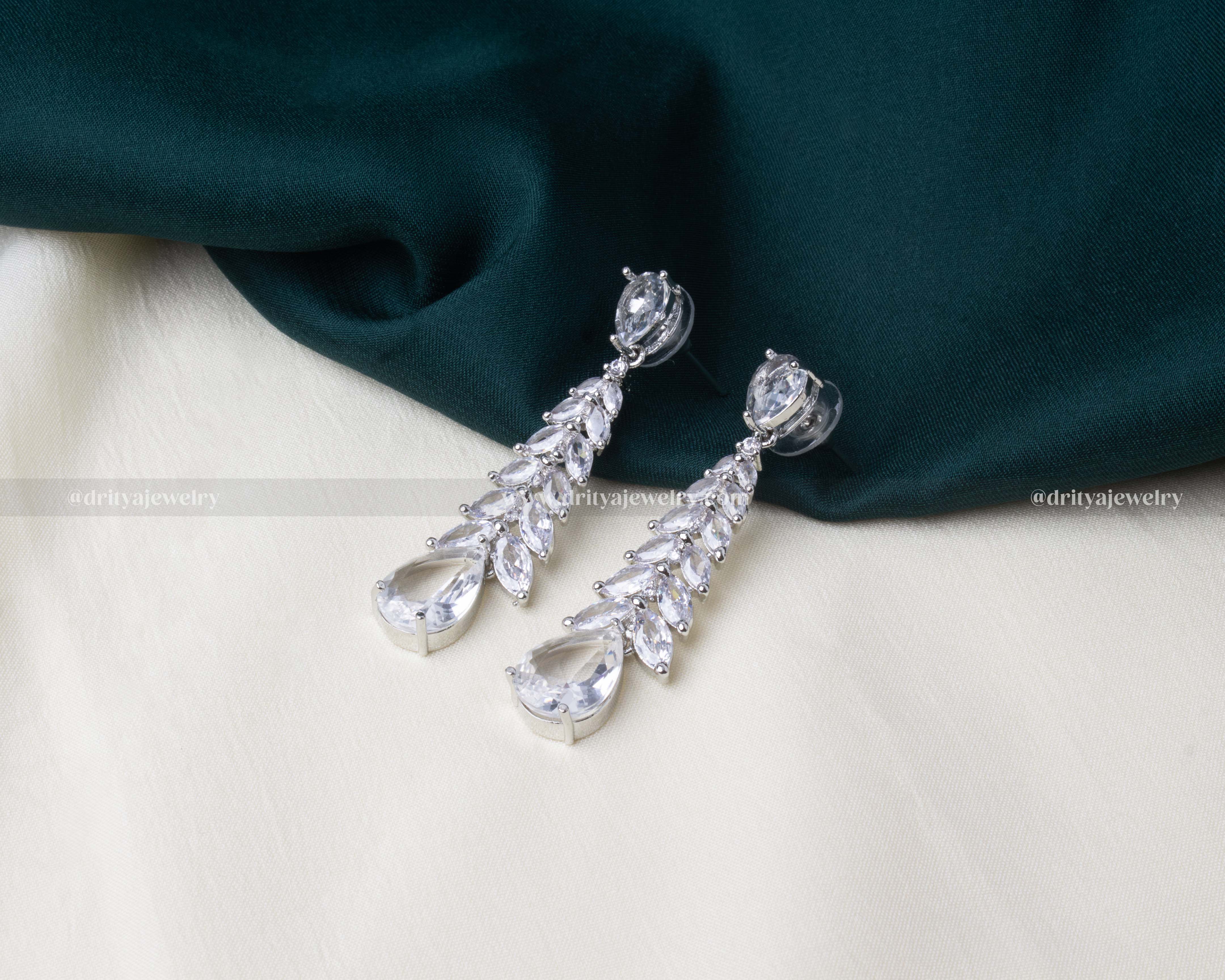 Premium white zircon dangler earrings with cascading marquise stones and teardrop finish.