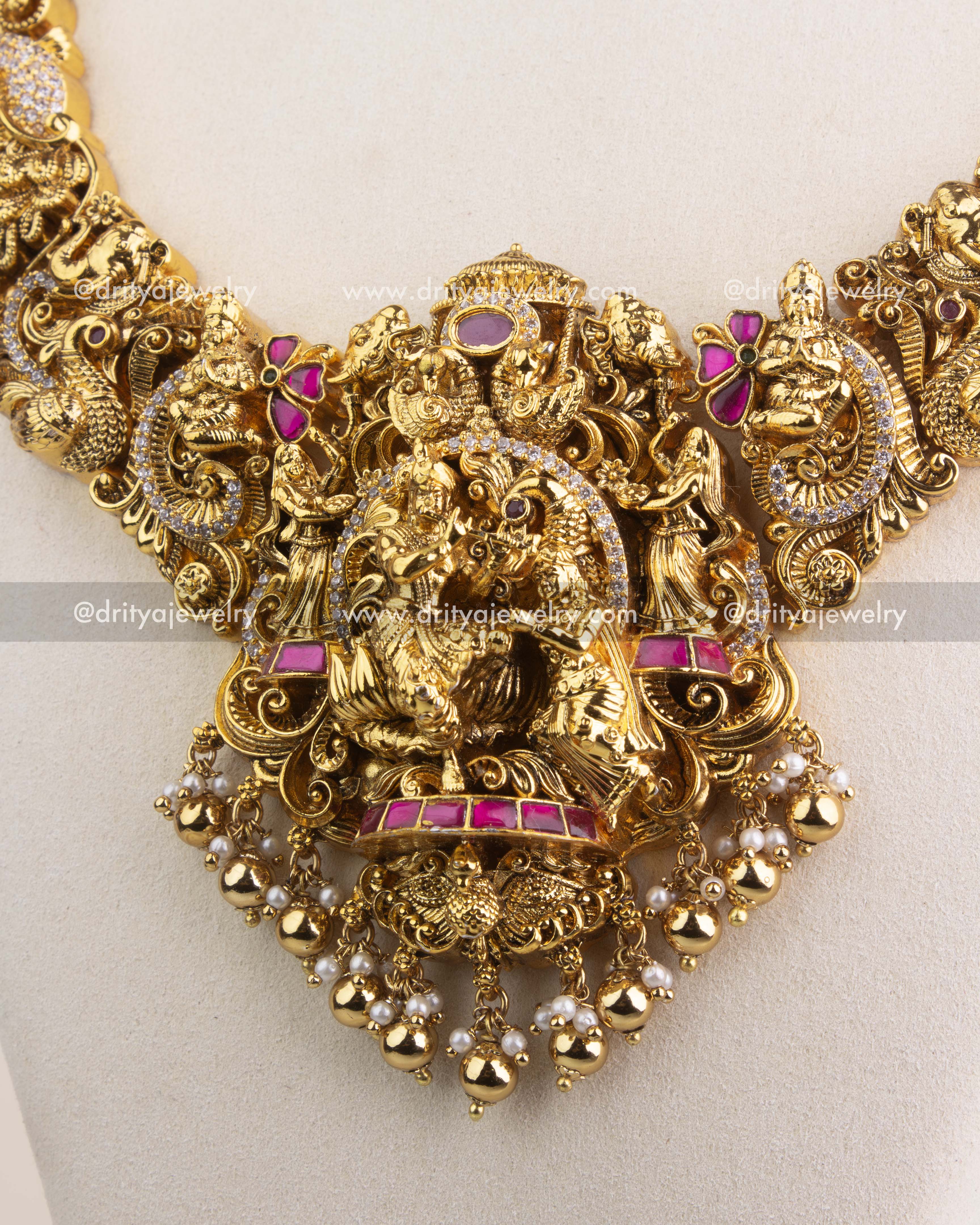 Premium kemp stone-studded Radha Krishna pendant with gold bead and pearl drops.