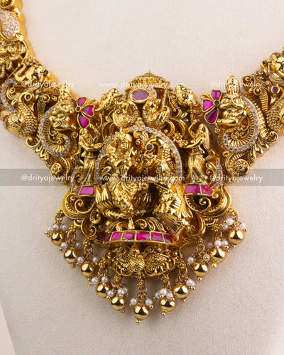 Premium kemp stone-studded Radha Krishna pendant with gold bead and pearl drops.