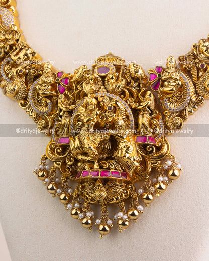 Premium kemp stone-studded Radha Krishna pendant with gold bead and pearl drops.