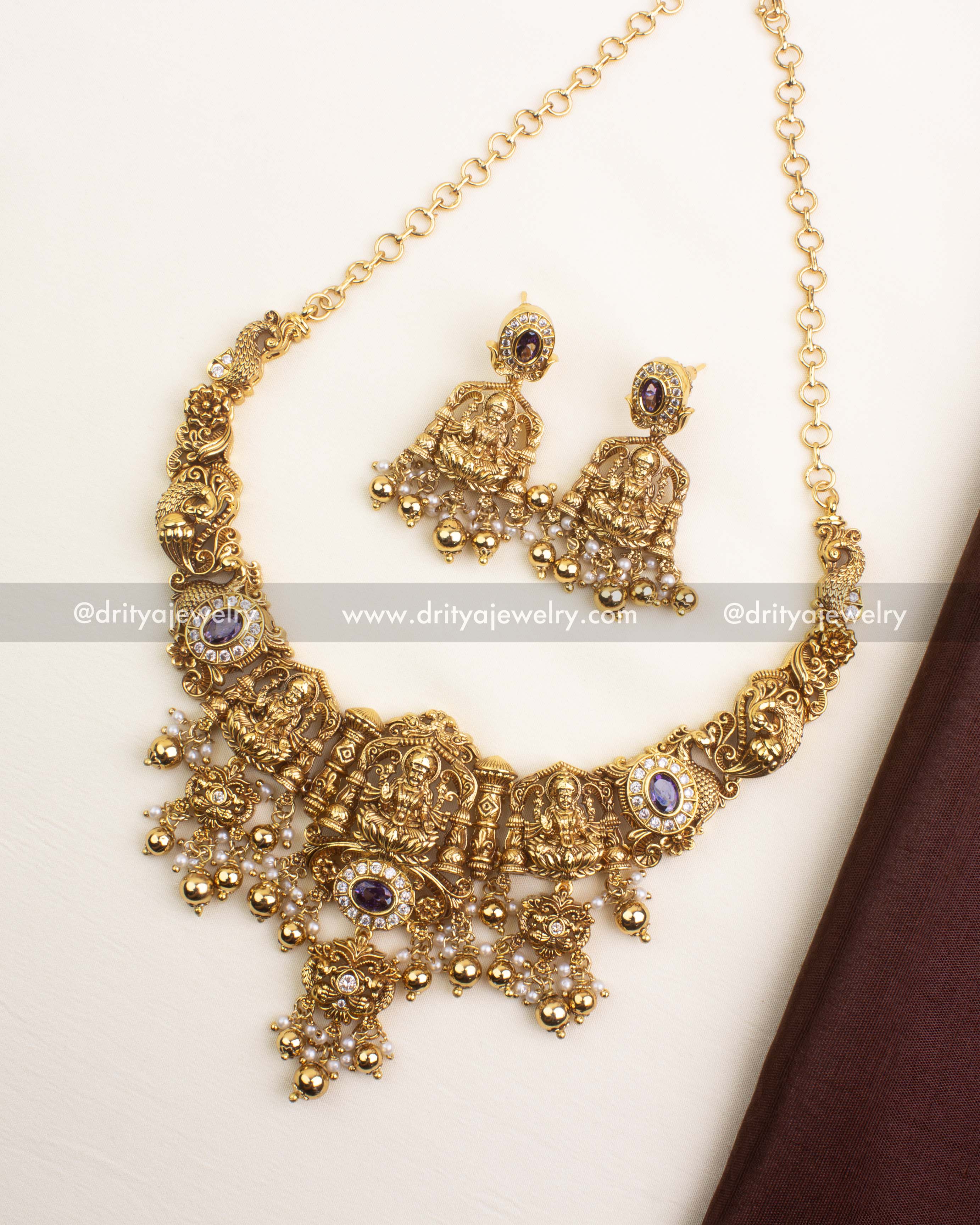 Premium nakshi necklace with Goddess motifs, purple bead drops, and antique gold finish.