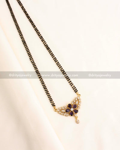Double-strand black beads necklace featuring a gold-plated purple floral pendant with CZ detailing.