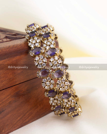 Antique gold Victorian bangle set with purple stones and white CZ detailing.