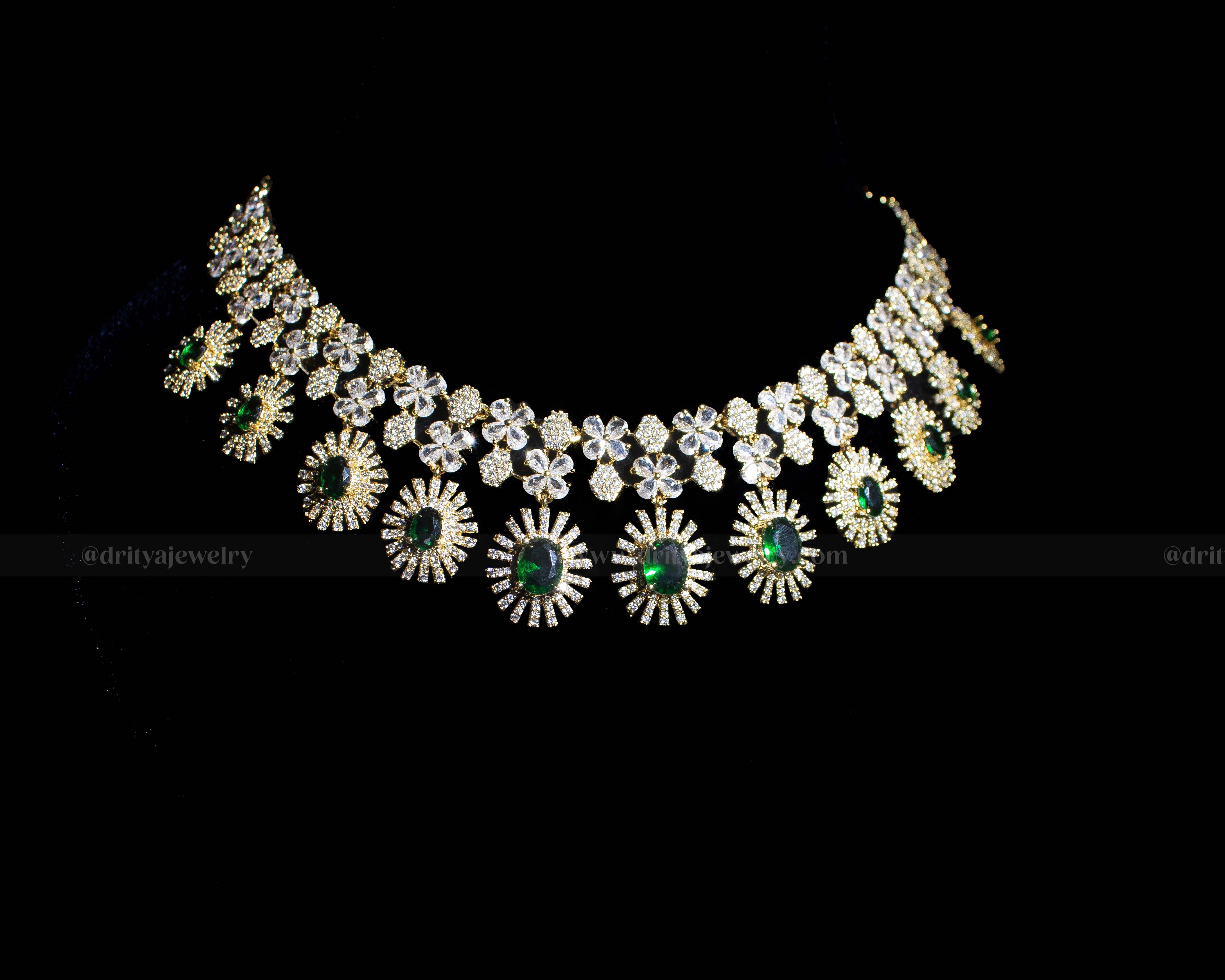 Full front view of the necklace displaying the elaborate design of CZ stones and emerald accents.