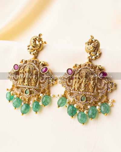 Gold-plated Ram Parivar earrings featuring mint green bead drops and detailed deity motifs.