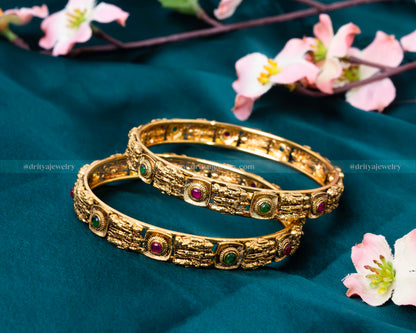 Dritya Jewelry Alt Text: Close-up of Ram Parivar Bangle Set highlighting the intricate designs and ruby and emerald gemstones by Dritya Jewelry.