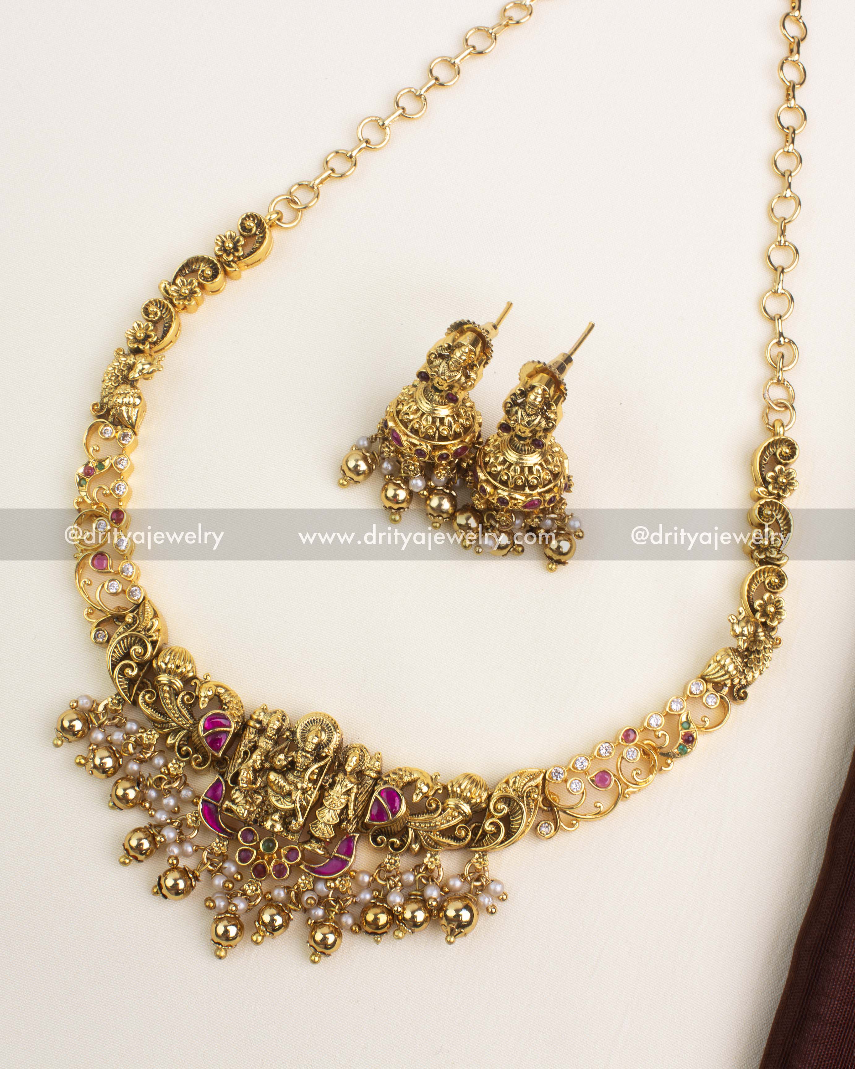 Antique gold temple short necklace with Ram Parivar motif, kemp stones, pearl and gold ball drops, paired with matching jhumka earrings by Dritya Jewelry.