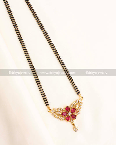 Gold-plated black beads necklace with a red floral pendant featuring CZ accents.
