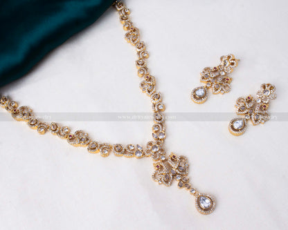 Elegant peacock motif necklace set in gold with sparkling reverse AD stones, ideal for weddings and formal occasions.